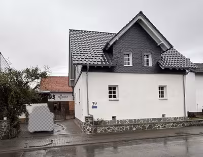 Einfamilienwohnhaus mit Nebengebäuden sowie rückseitig angrenzendes, unbebautes Grundstück in Sohlbaum, 35641 Schöffengrund, Schwalbach - Bild 1
